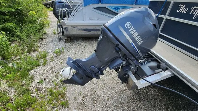 Slide: The Image of A Yamaha outboard motor is attached to a boat on a gravel surface. - 4