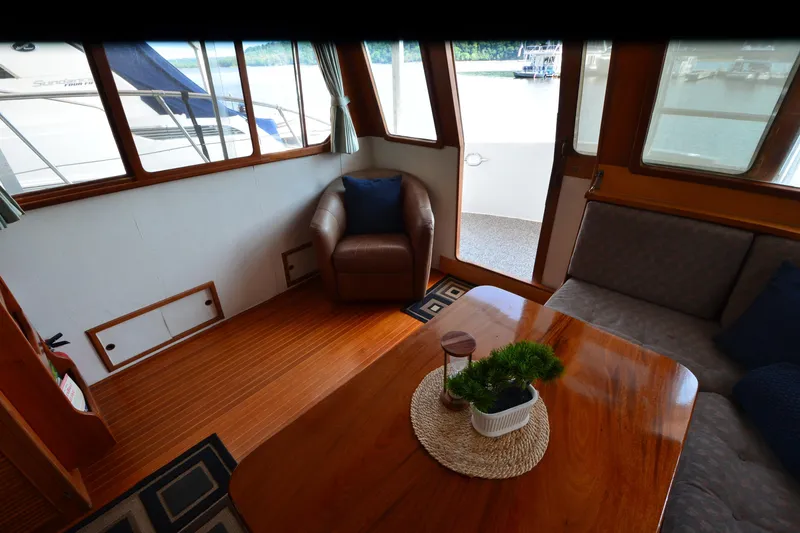 Slide: The Image of Interior of 1985 Kha Shing 40 yacht with wooden flooring and cozy seating area. - 27