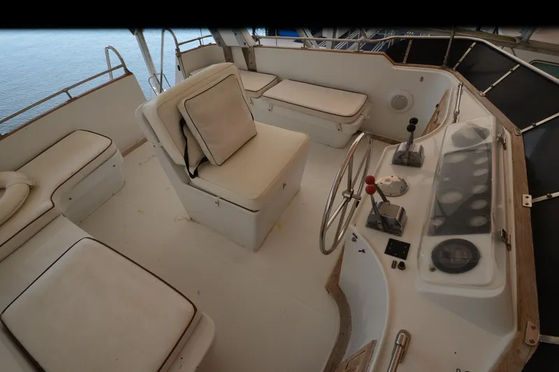 Slide: The Image of Interior view of 1985 Kha Shing 40 yacht helm with cushioned seating and steering wheel. - 15