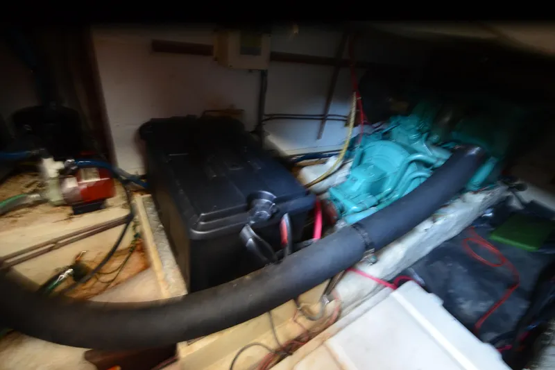 Slide: The Image of Engine room of a 1985 Kha Shing 40 yacht, featuring mechanical components and wiring. - 39