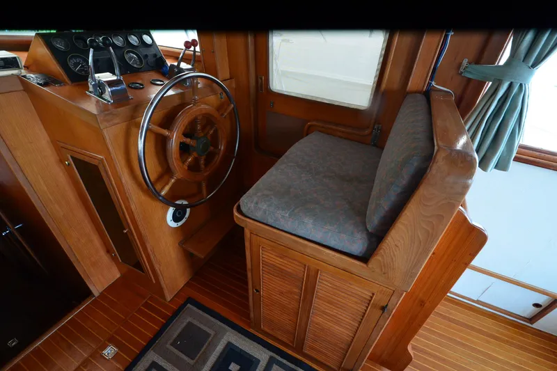 Slide: The Image of Wooden helm station of a 1985 Kha Shing 40 yacht with steering wheel and controls. - 29