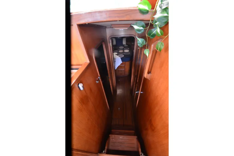 Slide: The Image of Interior view of 1985 Kha Shing 40 yacht with wooden finish and plants. - 31