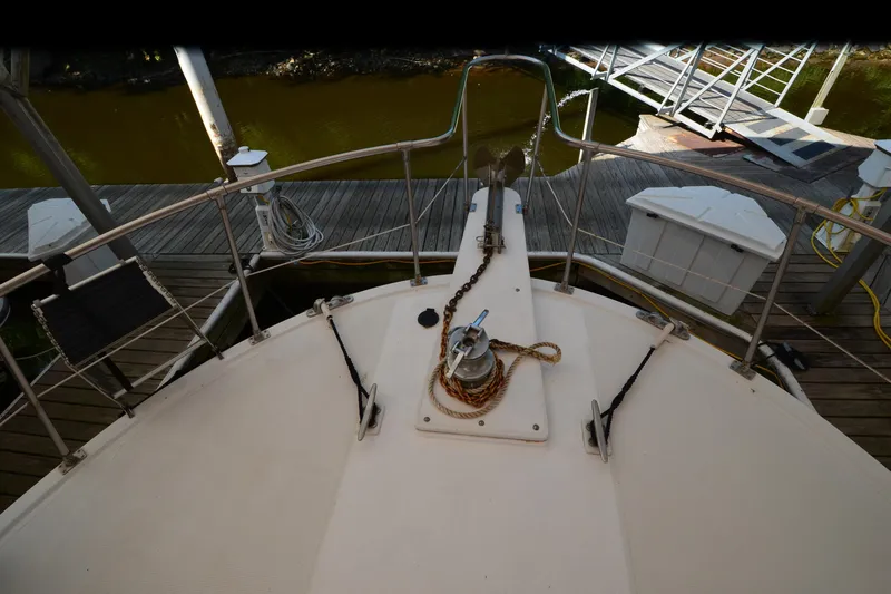 Slide: The Image of Bow view of 1985 Kha Shing 40 yacht docked at marina with anchor and ropes. - 20