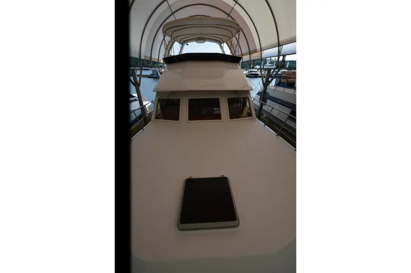 Slide: The Image of 1985 Kha Shing 40 yacht under canopy, docked at marina. - 22