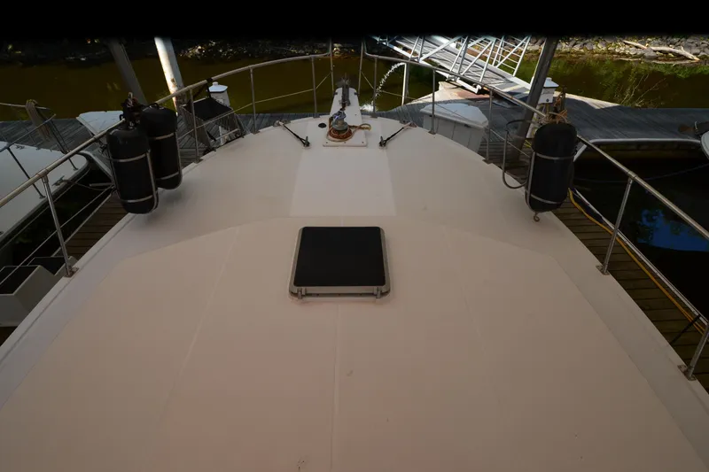 Slide: The Image of 1985 Kha Shing 40 yacht deck view with docked surroundings. - 19