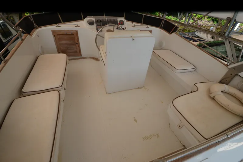 Slide: The Image of 1985 Kha Shing 40 boat interior with white seating and steering console. - 12