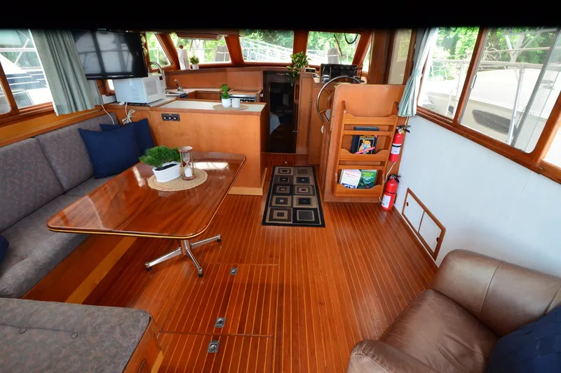 Slide: The Image of Interior of 1985 Kha Shing 40 yacht with wooden flooring and cozy seating area. - 25