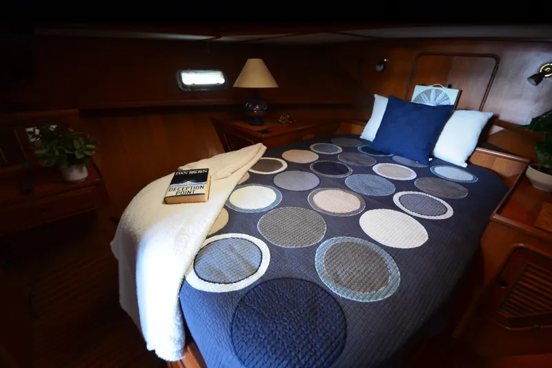 Slide: The Image of Cozy cabin bedroom in 1985 Kha Shing 40 yacht with patterned bedding and book. - 33