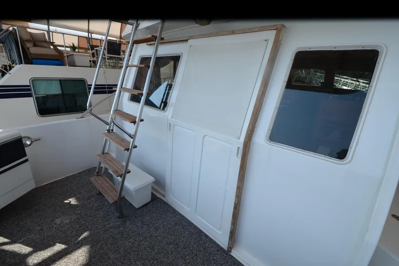 Slide: The Image of 1985 Kha Shing 40 yacht interior with stairs and windows. - 11