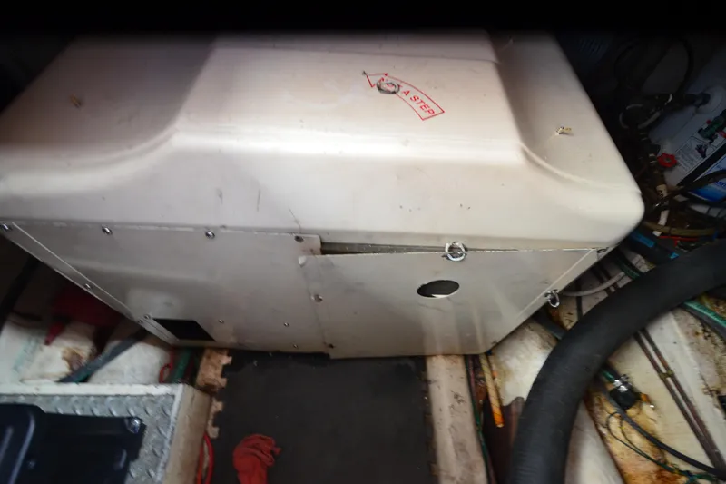 Slide: The Image of Engine compartment of a 1985 Kha Shing 40 boat, showing machinery and hoses. - 37