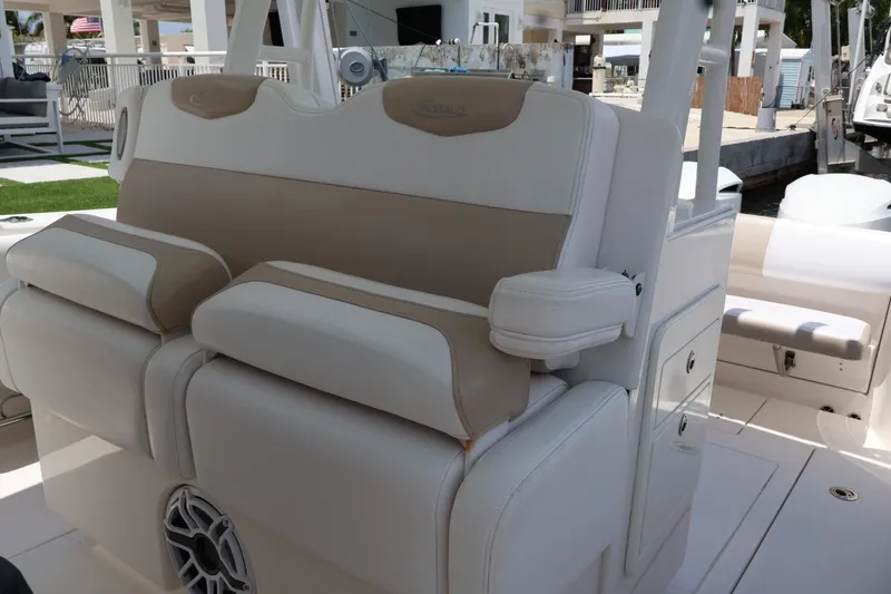Slide: The Image of 2018 Robalo R302 Center Console boat interior with beige and white seating. - 11