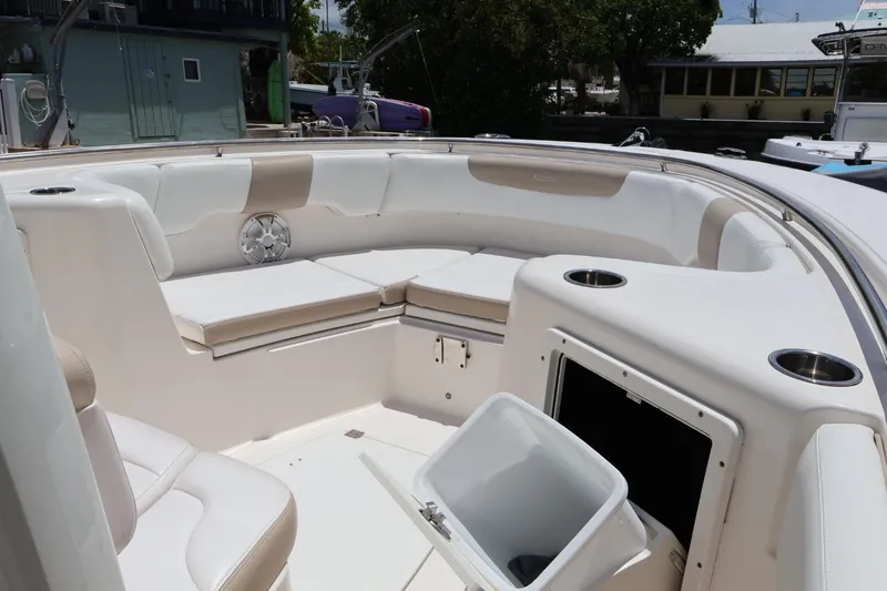 Slide: The Image of 2018 Robalo R302 Center Console boat interior with cushioned seating and storage compartments. - 7