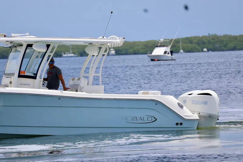 Slide: The Image of 2018 Robalo R302 Center Console boat cruising on calm waters. - 5
