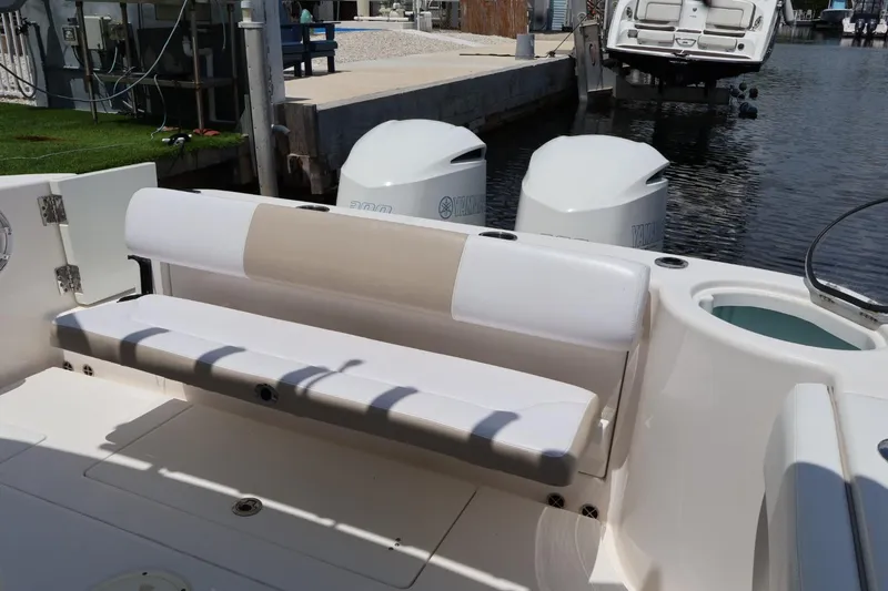 Slide: The Image of 2018 Robalo R302 Center Console boat with Yamaha engines at dockside. - 15