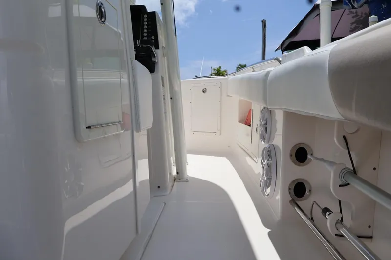 Slide: The Image of 2018 Robalo R302 Center Console boat interior with storage compartments and seating. - 14