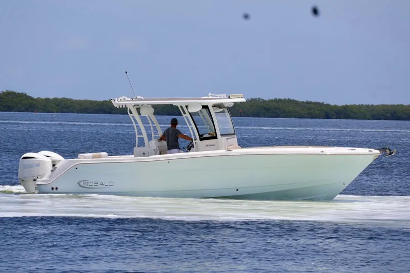Slide: The Image of 2018 Robalo R302 Center Console boat cruising on a calm blue sea. - 2