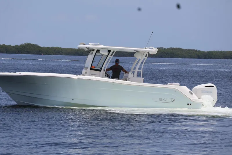 Slide: The Image of 2018 Robalo R302 Center Console boat cruising on open water. - 3