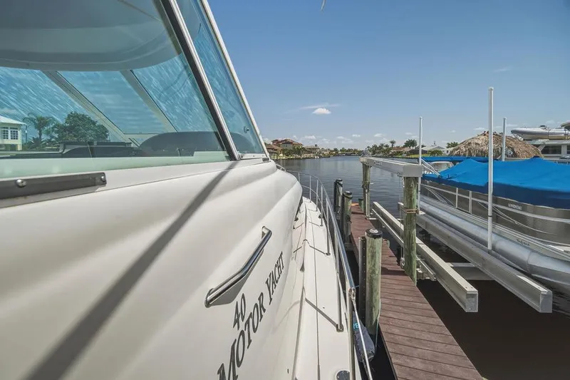 Slide: The Image of 2006 Sea Ray 40 Motor Yacht docked at marina under clear blue sky. - 5
