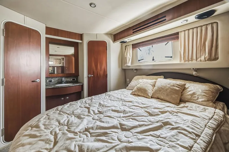 Slide: The Image of Luxurious bedroom interior of 2006 Sea Ray 40 Motor Yacht with elegant bedding and wood accents. - 16