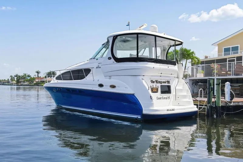Slide: The Image of 2006 Sea Ray 40 Motor Yacht docked, featuring sleek design and blue hull. - 3