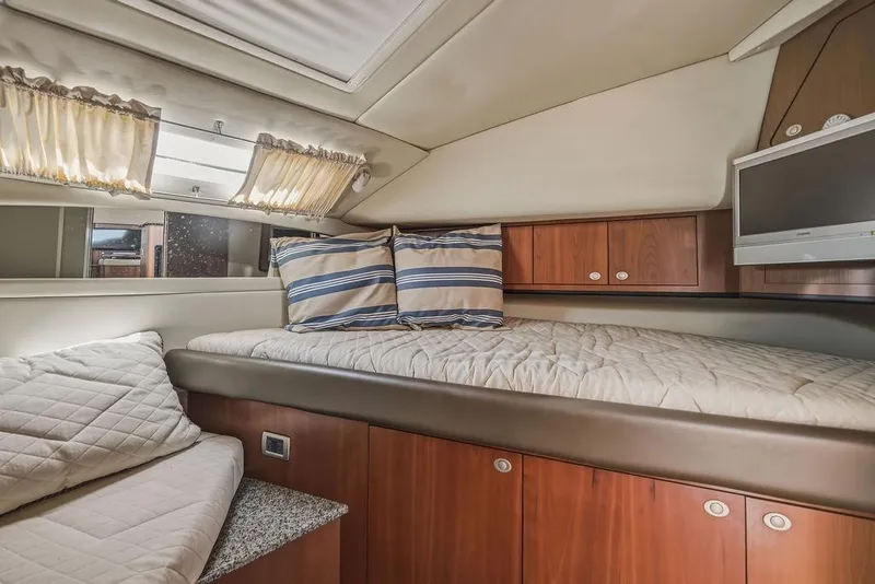 Slide: The Image of Luxurious cabin interior of 2006 Sea Ray 40 Motor Yacht with cozy bedding and wood cabinetry. - 18