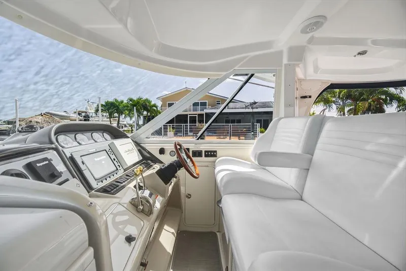 Slide: The Image of Interior view of 2006 Sea Ray 40 Motor Yacht cockpit with modern controls and seating. - 9