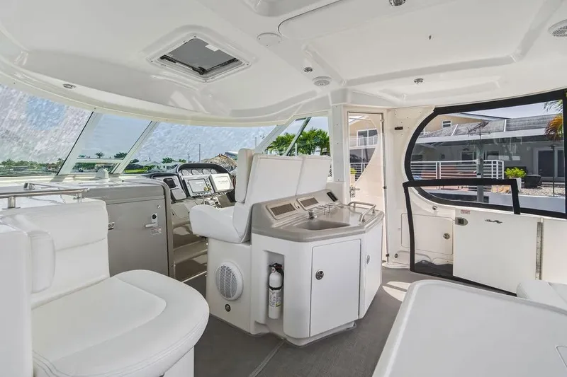 Slide: The Image of Interior of a 2006 Sea Ray 40 Motor Yacht, featuring sleek white seating and modern controls. - 7