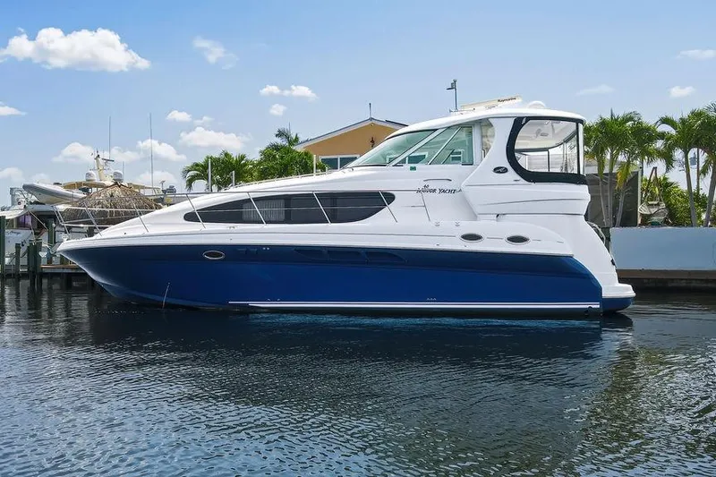 Slide: The Image of 2006 Sea Ray 40 Motor Yacht docked on calm water, under a clear blue sky. - 2