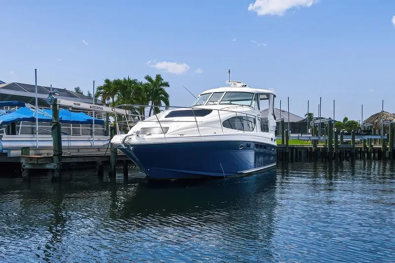 The Image of 2006 Sea Ray 40 Motor Yacht docked in a marina under a clear blue sky. - 1