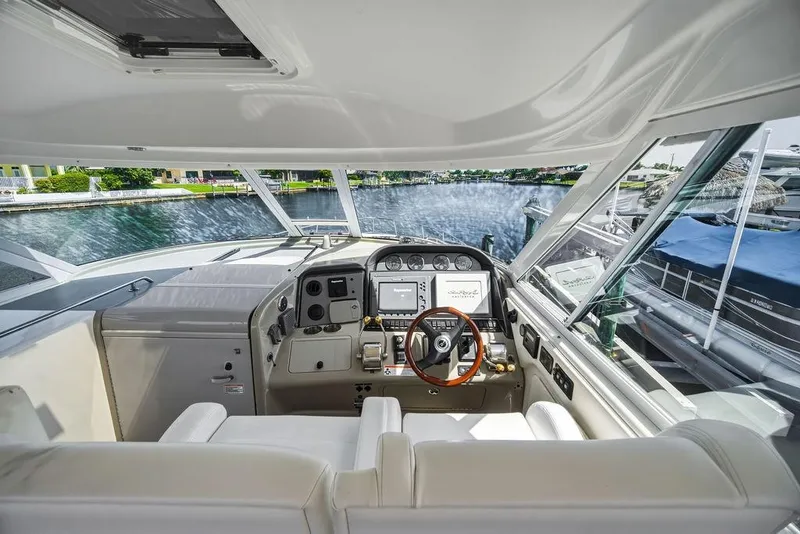 Slide: The Image of 2006 Sea Ray 40 Motor Yacht helm with modern controls and waterfront view. - 10