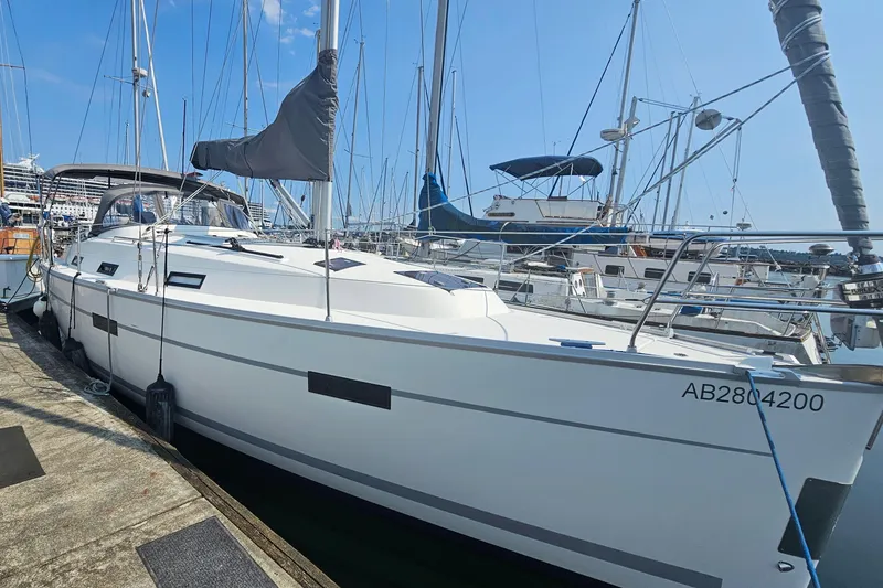 The Image of 2011 Bavaria Cruiser 36 yacht docked at marina, surrounded by other sailboats. - 2