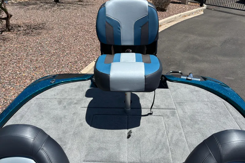 Slide: The Image of 2027 Nitro Z17 boat interior with blue and gray seating on a sunny day. - 12