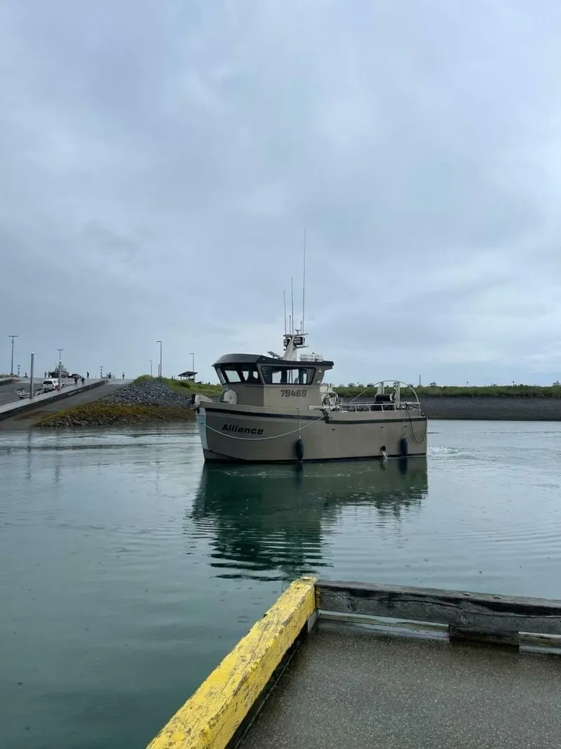 Slide: The Image of A modern boat with an enclosed wheelhouse navigates a calm harbor. - 5