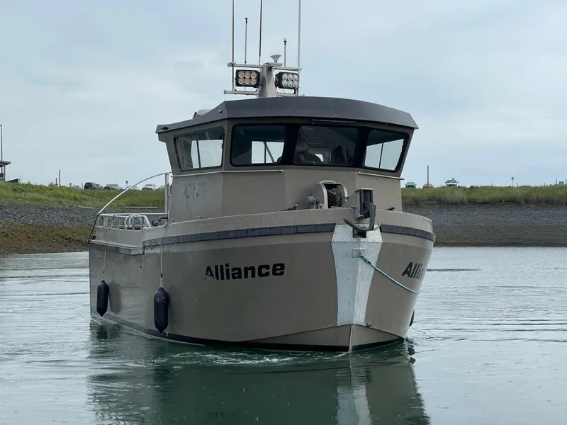 Slide: The Image of A modern boat with a sturdy design, cruising on calm water. It features an enclosed helm. - 1