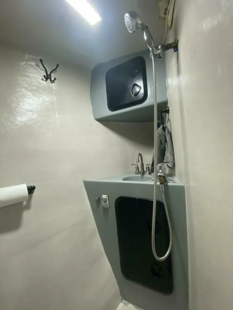 Slide: The Image of A modern bathroom with a gray sink, faucet, and showerhead in a boat. - 41