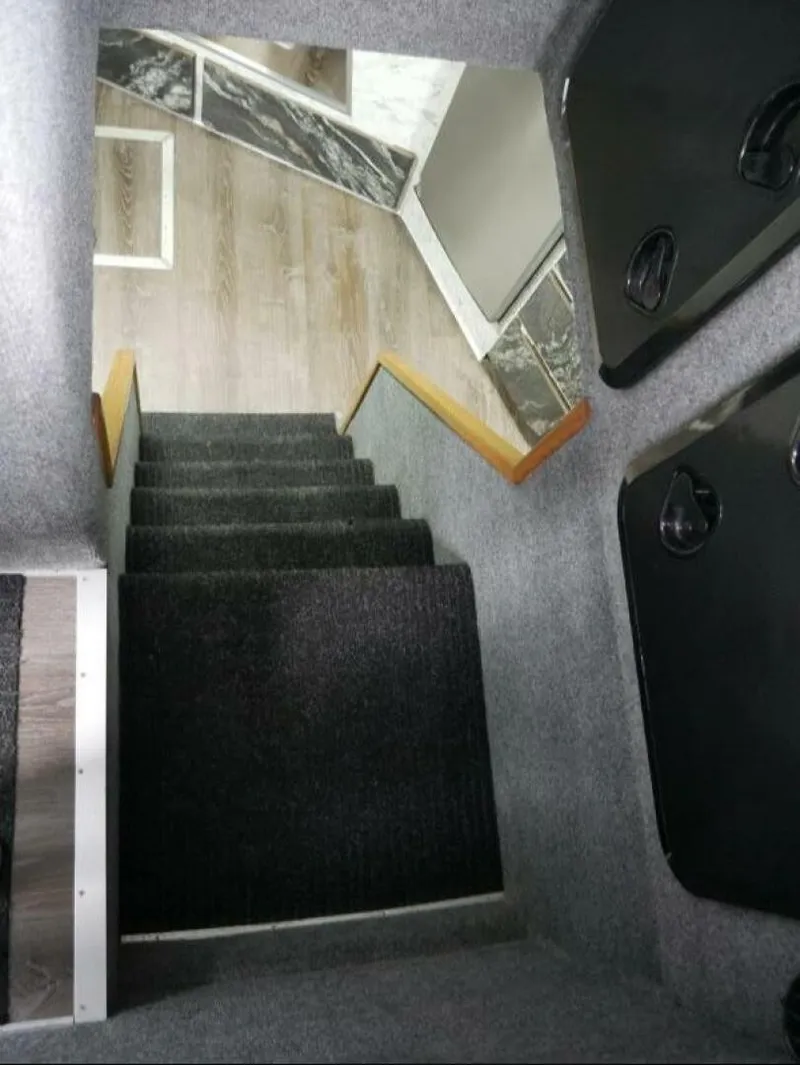 Slide: The Image of Carpeted stairs lead into a boat's interior. Walls are gray with wood accents. - 31
