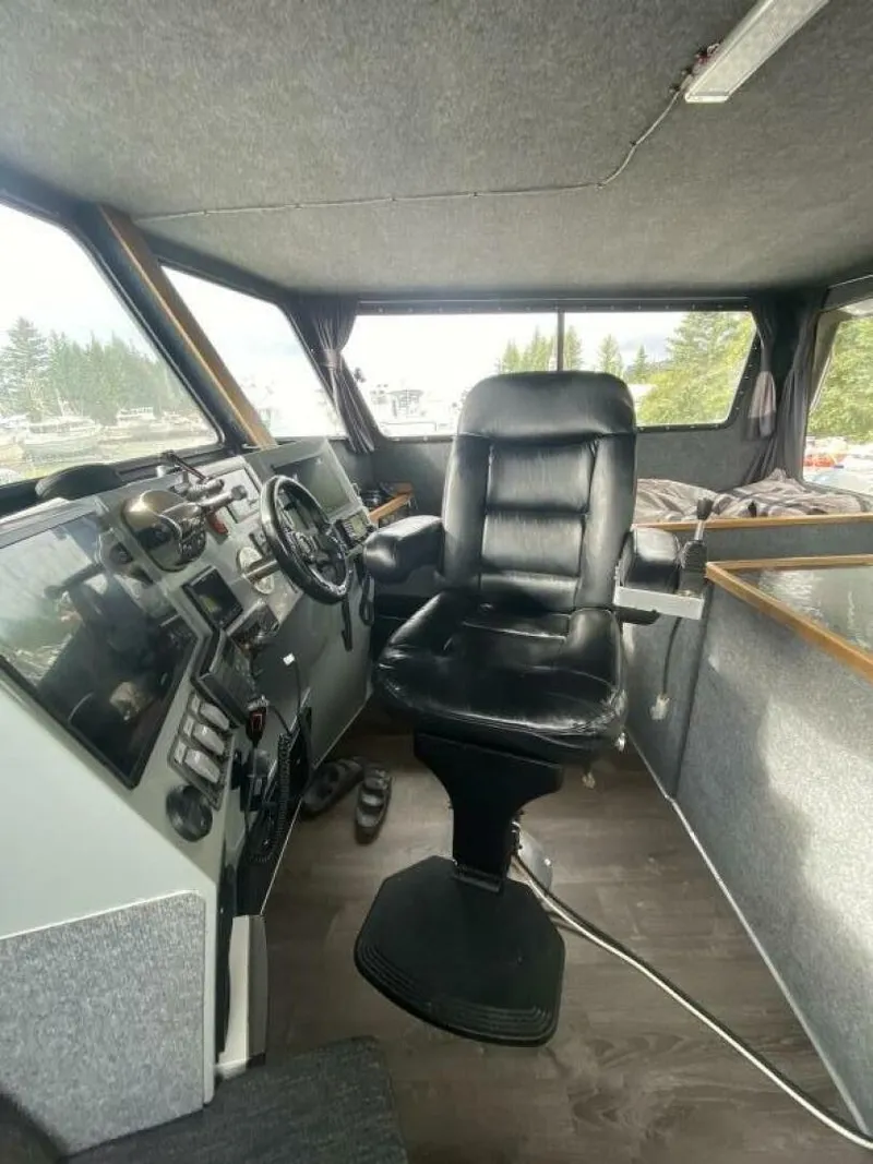 Slide: The Image of The image shows the cockpit of a 2022 Custom Freestyle Marine 32 boat with a black captain's chair. - 4