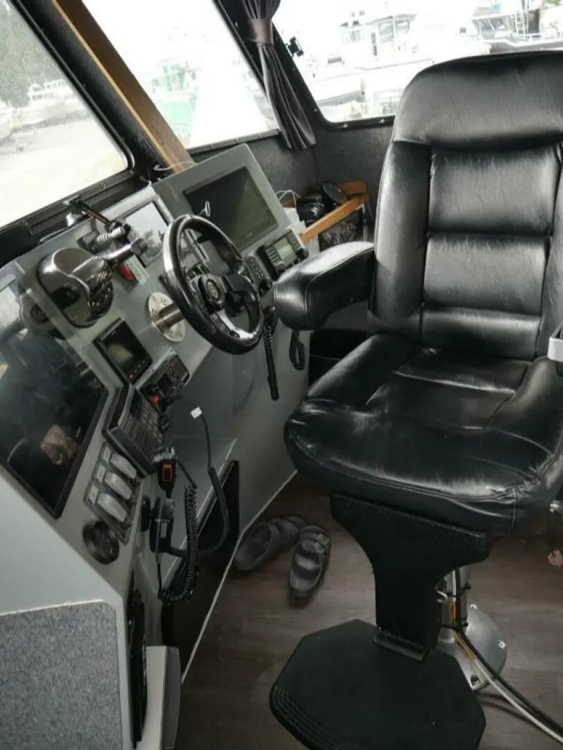 Slide: The Image of The image shows a boat's helm with a black leather seat and various instruments. - 12
