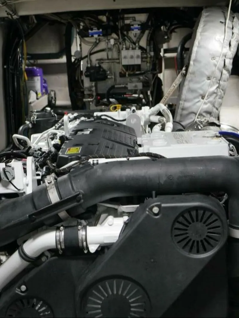 Slide: The Image of The engine room of a 2022 Custom Freestyle Marine 32 boat with complex wiring and pipes. - 35
