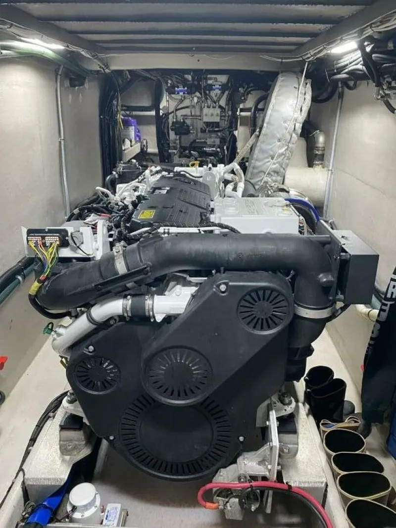 Slide: The Image of The engine room of a 2022 Custom Freestyle Marine 32 boat features a large engine with various hoses and cables. - 42