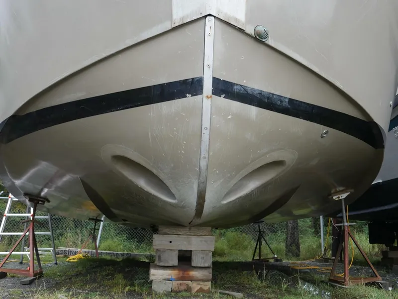 Slide: The Image of The bow of a 2022 Custom Freestyle Marine 32 boat, propped on wooden blocks. - 7