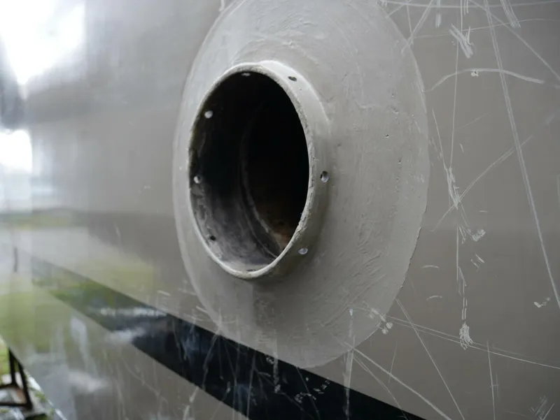 Slide: The Image of Close-up of a round exhaust port on a boat hull. - 9