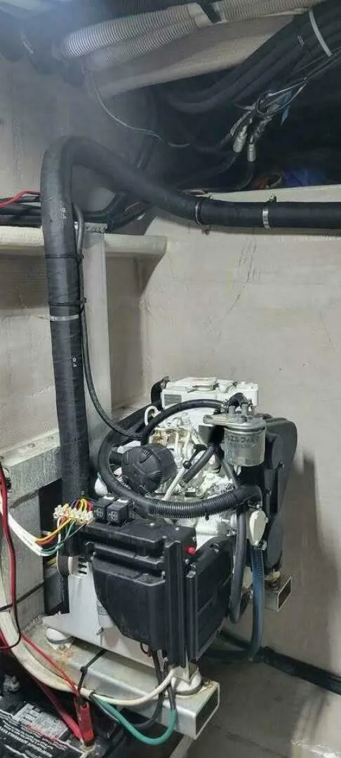 Slide: The Image of An engine compartment with a compact engine, surrounded by cables and hoses. - 21