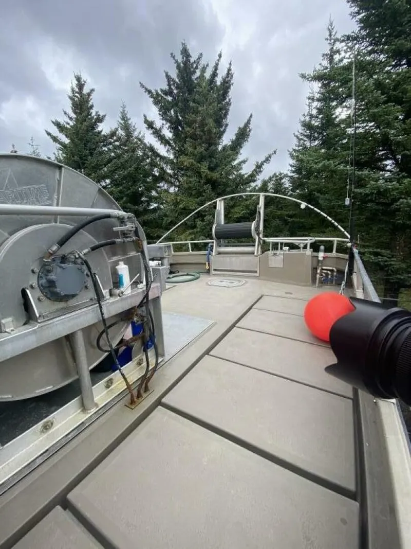 Slide: The Image of The boat features an open deck with a large red fender and a winch mechanism. - 37