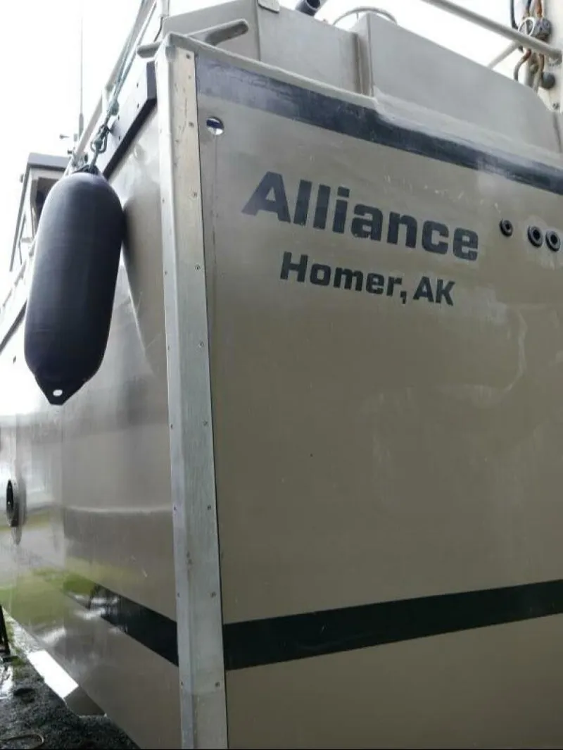 Slide: The Image of The image shows the stern of a boat named "Alliance" with home port "Homer, AK." - 14