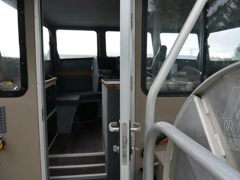 Slide: The Image of The image shows the interior of a boat with gray seating and a helm station. - 28