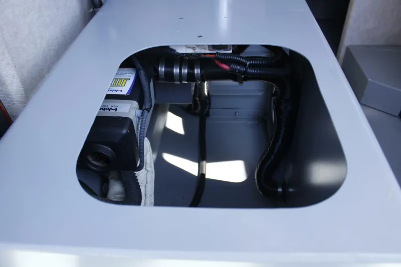 Slide: The Image of A view inside a boat's engine compartment with visible cables and components. - 35