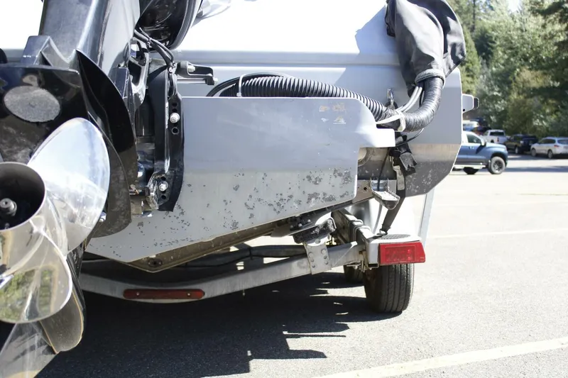 Slide: The Image of A boat on a trailer showing the motor and propellers. It is parked in a lot. - 18