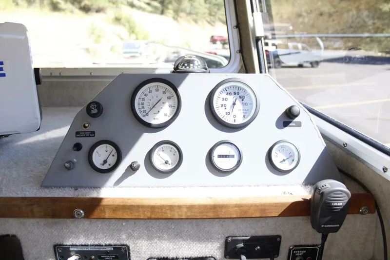 Slide: The Image of The image shows a boat dashboard with several gauges and a radio. - 32