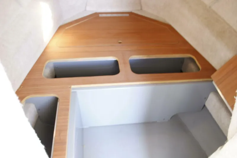 Slide: The Image of Interior of a 2005 ACB 27 with wood paneling and storage compartments. - 44